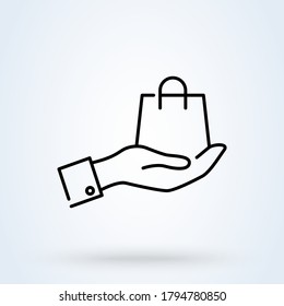 A hand holding shopping bag linear style. Bag line icon. vector Illustration fashion handbag.