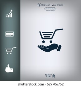 hand holding a shopping cart online store. icon. Vector Eps 10