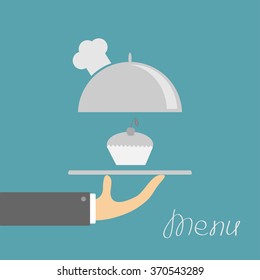 Hand holding silver platter cloche with chefs hat. Menu card. Blue background. Flat design. Vector illustration