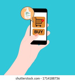 Hand holding smart phone with buy button on the screen. Contactless online purchase of goods using your phone. Hand sanitizer and Alcohol gel. Diseases prevention (coronavirus) concept. 