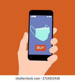 Hand holding smart phone with buy button on the screen. Contactless online purchase of goods using your phone. Use protective mask. Home delivery. Disease prevention concept.