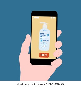 Hand holding smart phone with buy button on the screen. Contactless online purchase of goods using your phone. Use Hand sanitizer pump bottle. Diseases prevention (coronavirus). Home delivery.