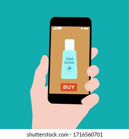 Hand holding smart phone with buy button on the screen. Contactless online purchase of goods using your phone. Use Hand sanitizer bottle. Diseases prevention (coronavirus). Home delivery.