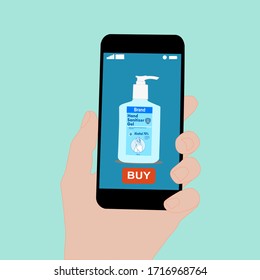 Hand holding smart phone with buy button on the screen. Contactless online purchase of goods using your phone. Use Hand sanitizer pump bottle. Diseases prevention (coronavirus). Home delivery.