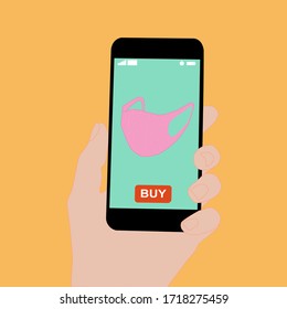 Hand holding smart phone with buy button on the screen. Contactless online purchase of goods using your phone. Use fabric mask. Home delivery. Disease prevention concept.