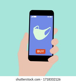 Hand holding smart phone with buy button on the screen. Contactless online purchase of goods using your phone. Use fabric mask. Home delivery. Disease prevention concept.