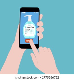 Hand holding smart phone and press buy button on the screen. Contactless online purchase of goods using your phone. Use Hand sanitizer tube. Diseases Wireless Technology. Home delivery.