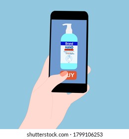 Hand holding smart phone and press buy button on the screen. Contactless online purchase of goods using your phone. Use Hand sanitizer tube. Diseases Wireless Technology. Home delivery.