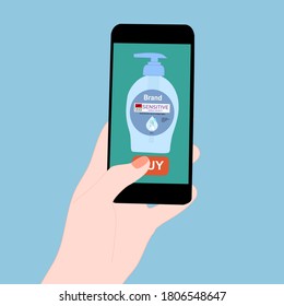 Hand holding smart phone and pressing buy button on the screen. Contactless online purchase of goods using your phone. Use Hand Soap pump bottle. Wireless technology. Home delivery.