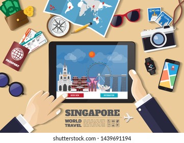 Hand holding smart tablet booking travel destination.Singapore famous places.Vector concept banners in flat style with the set of traveling objects, accessories and tourism icon.