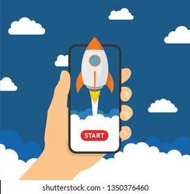 Hand holding smartphon with launch rocket on the screen - stock 