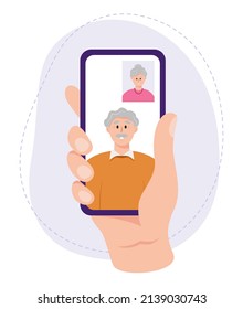 A hand holding a smartphone with active video call on the touch screen. Senior family couple chatting online with camera. Vector illustration in flat style isolated on white background.