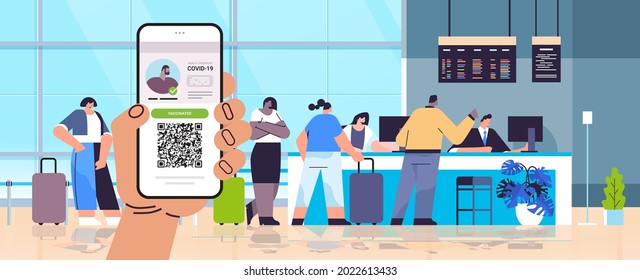 hand holding smartphone with digital immunity passport with qr code on screen risk free covid-19 pandemic