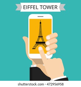 Hand holding smartphone with Eiffel Tower on the screen. Vector flat illustration.