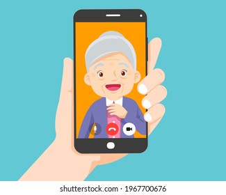 Hand holding smartphone with elderly on screen.Video call with grandparents or aging parents.