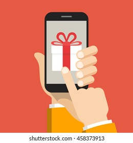 Hand holding smartphone with gift box on the screen. Finger touch the box. Vector flat illustration.