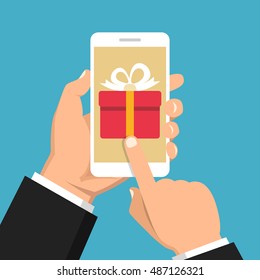 Hand holding smartphone with gift box on the screen. Finger touch the button. Vector flat illustration.