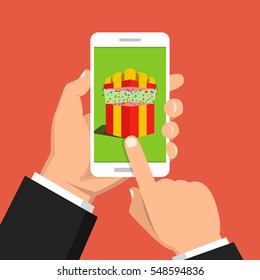 Hand holding smartphone with gift box on the screen. Finger touch the button. Vector flat illustration.