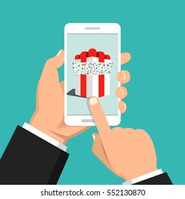 Hand holding smartphone with gift box on the screen. Finger touch the button. Vector flat illustration.