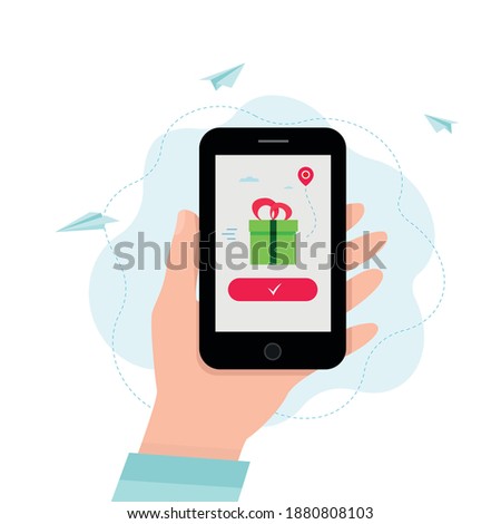 Hand holding smartphone with gift box on a screen.