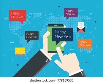 Hand holding smartphone with Happy New Year message. Map of the world, email and video with message of happy new year. Concept of social media, communication and connection between people.