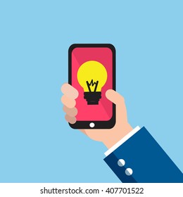hand holding smartphone with light bulb