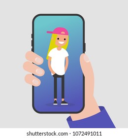 Hand holding a smartphone. Millennial character standing on a mobile phone screen. Flat editable vector illustration, clip art