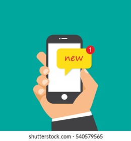 Hand holding smartphone with new message on screen.