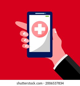 Una mano sostiene un smartphone, en pantalla muestra el concepto de símbolo de emergencia cruzada blanca, fondo rojo