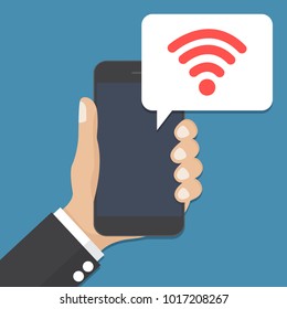 Hand holding smartphone with speech bubble and wifi icon