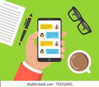 Hand holding smartphone with text messaging on the screen. cup of coffee, notebook with pen and glasses lay on the table. Vector illustration.
