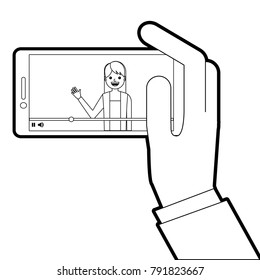 hand holding smartphone with video blogger on screen