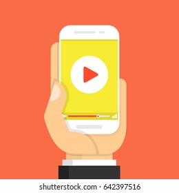 Hand holding smartphone with video player on the screen. Movie app concept. Flat cartoon style. Vector illustration.