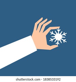 Hand holding snowflake isolated on background. Vector illustration. Flat style