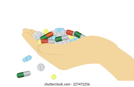 Hand holding some pills of different shapes  