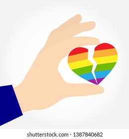 Hand holding a split heart in the colors of LGBT, flat design