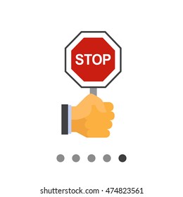 Hand holding stop sign
