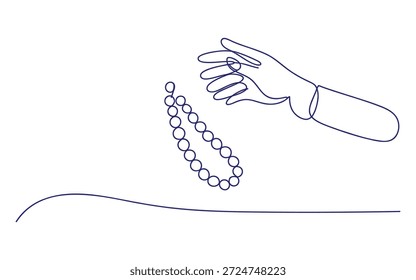 Uma mão segurando uma corda de pérolas sobre uma superfície azul joias