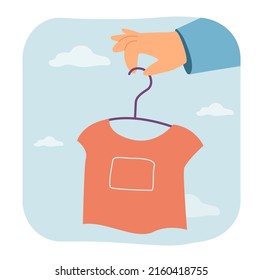 Hand holding stylish shirt on clothes hanger. Slow ethical fashion and conscious eco consumption for person flat vector illustration. Second hand concept for banner, website design or landing web page