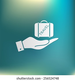 hand holding a symbol of a suitcase for travel. Travel Bag