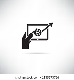 hand holding table and bitcoin graph icon
