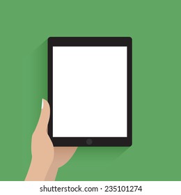Hand holding tablet computer with blank screen. Green background.