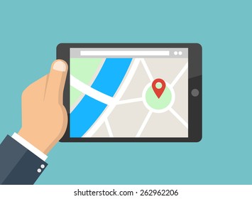 Hand holding tablet pc with street map and map pointer - Mobile gps navigation concept