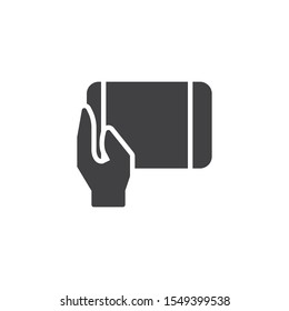 Hand holding tablet vector icon. filled flat sign for mobile concept and web design. Using tablet pad glyph icon. Symbol, logo illustration. Vector graphics