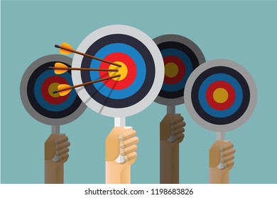 Hand holding target with arrow.