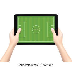 Hand holding touch screen tablet computer with soccer field background. Vector illustration.