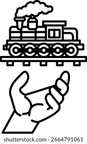 A hand is holding a train. The train is on a track. The train is black and white