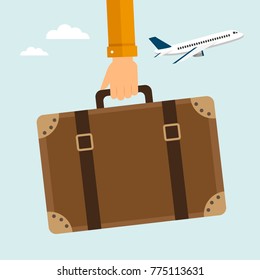 Hand holding travel suitcase with stickers. Vector illustration.