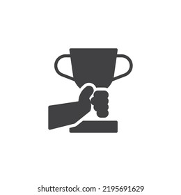 Hand holding trophy cup vector icon. filled flat sign for mobile concept and web design. Champion award cup glyph icon. Symbol, logo illustration. Vector graphics