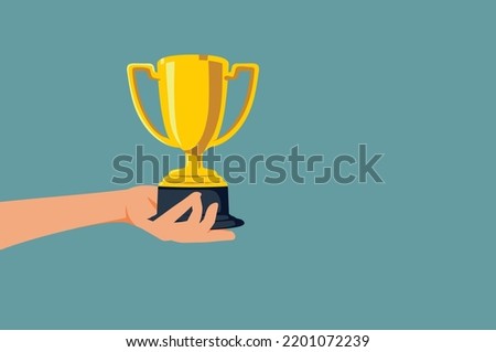 
Hand Holding Trophy for the Winner Vector Cartoon Illustration. Person receiving a golden cup prize in a competition 
